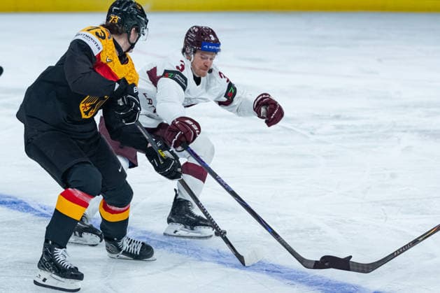 ZURICH, SWITZERLAND - MAY 17: -13ger- in the battle for the puck with Alberts Smits (Latvia, 3) during the Preliminary Round - Group A Match 15 between Germany and Latvia at the IIHF Ice hockey, Eishockey World Championship, WM, Weltmeisterschaft 2026, Swiss Life Arena on May 17, 2026 in Zurich, Switzerland. Zurich Switzerland Copyright: xTimoxSteinx