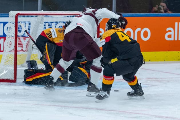 ZURICH, SWITZERLAND - MAY 17: Philipp Grubauer (Germany, 30) gets the puck from Oskars Batna (Latvia, 95) during the Preliminary Round - Group A Match 15 between Germany and Latvia at the IIHF Ice hockey, Eishockey World Championship, WM, Weltmeisterschaft 2026, Swiss Life Arena on May 17, 2026 in Zurich, Switzerland. Zurich Switzerland Copyright: xTimoxSteinx