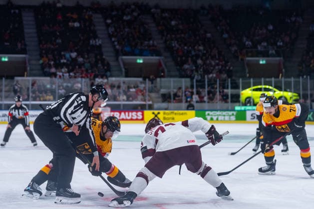 ZURICH, SWITZERLAND - MAY 17: Stefan Loibl (Germany, 15) in the battle for the puck with Deniss Smirnovs (Latvia, 73) from Brian Birkhoff (Linesperson) during the Preliminary Round - Group A Match 15 between Germany and Latvia at the IIHF Ice hockey, Eishockey World Championship, WM, Weltmeisterschaft 2026, Swiss Life Arena on May 17, 2026 in Zurich, Switzerland. Zurich Switzerland Copyright: xTimoxSteinx