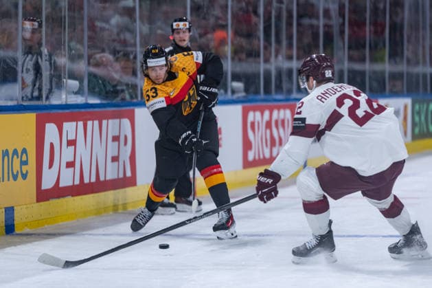 ZURICH, SWITZERLAND - MAY 17: Toms Andersons (Latvia, 22) in a duel against Moritz Seider (Germany, 53) during the Preliminary Round - Group A Match 15 between Germany and Latvia at the IIHF Ice hockey, Eishockey World Championship, WM, Weltmeisterschaft 2026, Swiss Life Arena on May 17, 2026 in Zurich, Switzerland. Zurich Switzerland Copyright: xTimoxSteinx