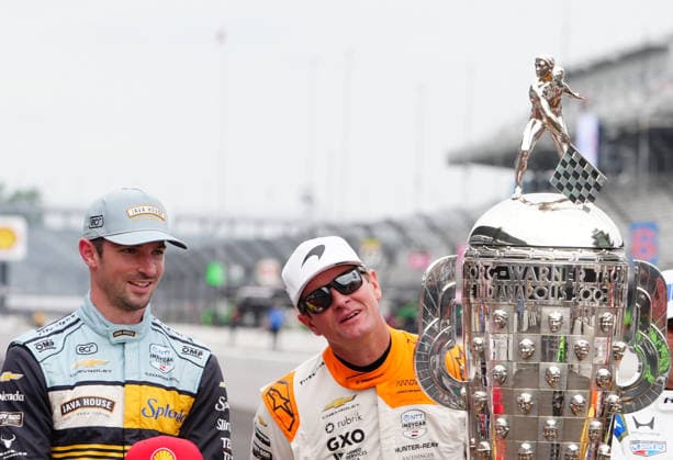 INDIANAPOLIS, IN - MAY 18: From left to right IndyCar, Indy Car, IRL, USA drivers Alexander Rossi and Ryan Hunter-Reay look at the Borg Warner Trophy before a group driver photo is taken before practice for the 110th Running of the Indianapolis 500 on May 18th, 2026, at the Indianapolis Motor Speedway in Indianapolis, Indiana. (Photo by Brian Spurlock Icon Sportswire) AUTO: MAY 18 NTT IndyCar Series Indianapolis 500 Practice EDITORIAL USE ONLY Icon26051850012