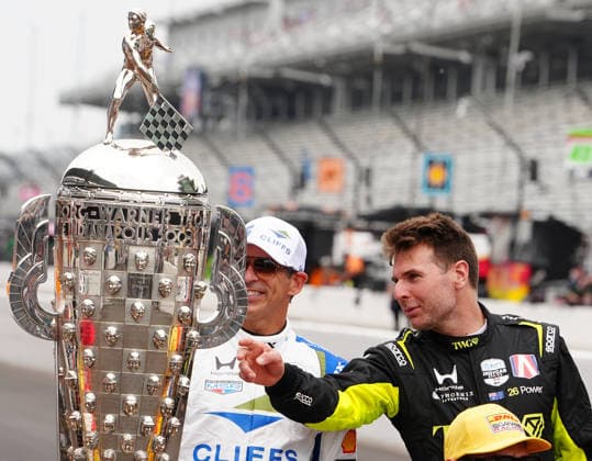 INDIANAPOLIS, IN - MAY 18: From left to right IndyCar, Indy Car, IRL, USA drivers Hello Castroneves and Will Power look at the Borg Warner Trophy before a group driver photo is taken before practice for the 110th Running of the Indianapolis 500 on May 18th, 2026, at the Indianapolis Motor Speedway in Indianapolis, Indiana. (Photo by Brian Spurlock Icon Sportswire) AUTO: MAY 18 NTT IndyCar Series Indianapolis 500 Practice EDITORIAL USE ONLY Icon26051850015