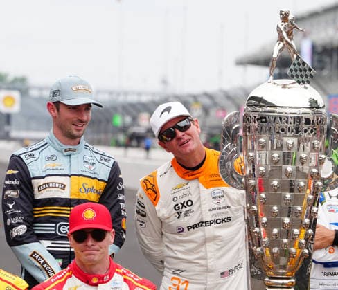 INDIANAPOLIS, IN - MAY 18: From left to right IndyCar, Indy Car, IRL, USA drivers Alexander Rossi and Ryan Hunter-Reay look at the Borg Warner Trophy before a group driver photo is taken before practice for the 110th Running of the Indianapolis 500 on May 18th, 2026, at the Indianapolis Motor Speedway in Indianapolis, Indiana. (Photo by Brian Spurlock Icon Sportswire) AUTO: MAY 18 NTT IndyCar Series Indianapolis 500 Practice EDITORIAL USE ONLY Icon26051850013
