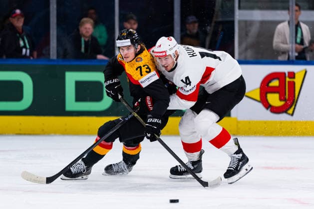 ZURICH, SWITZERLAND - MAY 18: Dean Kukan (Switzerland, 14) and Lukas Reichel (Germany, 73) fighting for the puck during the Preliminary Round - Group A Match 19 between Germany and Switzerland at the IIHF Ice hockey, Eishockey World Championship, WM, Weltmeisterschaft 2026, Swiss Life Arena on May 18, 2026 in Zurich, Switzerland. Zurich Switzerland Copyright: xTimoxSteinx