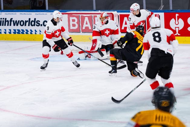 ZURICH, SWITZERLAND - MAY 18: Leonardo Genoni (Switzerland, 63) catching the puck from Daniel Fischbuch (Germany, 71) during the Preliminary Round - Group A Match 19 between Germany and Switzerland at the IIHF Ice hockey, Eishockey World Championship, WM, Weltmeisterschaft 2026, Swiss Life Arena on May 18, 2026 in Zurich, Switzerland. Zurich Switzerland Copyright: xTimoxSteinx
