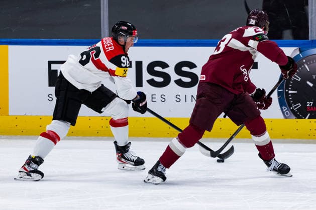 ZURICH, SWITZERLAND - MAY 19: Mario Huber (Austria, 96) in the battle for the puck with Sandis Vilmanis (Latvia, 23) during the Preliminary Round - Group A Match 21 between Latvia and Austria at the IIHF Ice hockey, Eishockey World Championship, WM, Weltmeisterschaft 2026, Swiss Life Arena on May 19, 2026 in Zurich, Switzerland. Zurich Switzerland Copyright: xTimoxSteinx