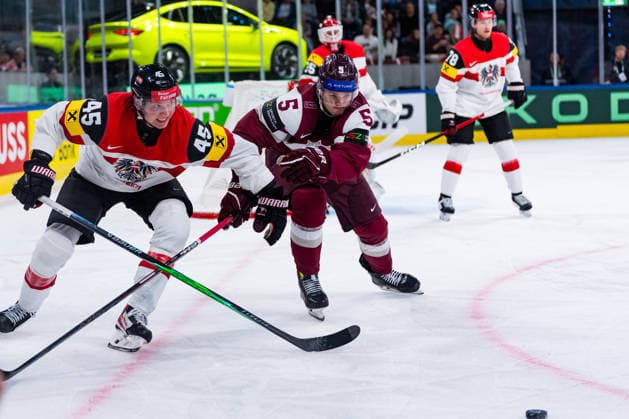 ZURICH, SWITZERLAND - MAY 19: Artus Andzans (Latvia, 5) in the battle for the puck with Gregor Biber (Austria, 45) during the Preliminary Round - Group A Match 21 between Latvia and Austria at the IIHF Ice hockey, Eishockey World Championship, WM, Weltmeisterschaft 2026, Swiss Life Arena on May 19, 2026 in Zurich, Switzerland. Zurich Switzerland Copyright: xTimoxSteinx