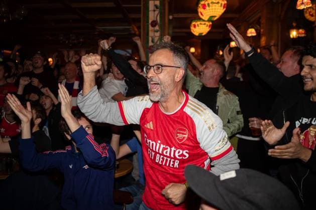 Fan of Arsenal celebrates as Eli Junior Kroupi of AFC Bournemouth (not pictured) scores his team s first goal Arsenal Fans Celebrate Premier League Title, Islington, London, UK - 19 05 2026 EDITORIAL USE ONLY No use with unauthorised audio, video, data, fixture lists, club league logos or live services. Online in-match use limited to 120 images, no video emulation. No use in betting, games or single club league player publications.  Copyright: xAnthonyxHanc Shutterstockx 16884298e