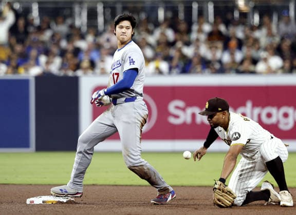 Baseball: Dodgers vs. Padres Los Angeles Dodgers designated hitter Shohei Ohtani (17) reaches second base after hitting a double as San Diego Padres shortstop Xander Bogaerts fails to collect the ball during the eighth inning of a baseball game against the San Diego Padres at Petco Park in San Diego, California, on May 19, 2026.  A14AA0005587294P