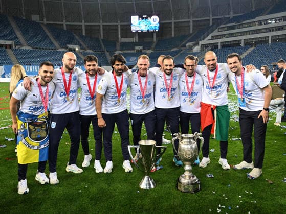 The staff led by Filipe Amaral Rino Coelho among them Romao Bruno Alexandre Rodrigues, Markus Berger and Mario Felgueiras pose next to the trophies won in the 2025 2026 season after the match between Universitatea Craiova and Universitatea Cluj, counting for the Superbet Super League Super League Play off, played at the Ion Oblemenco Stadium in Craiova, Sunday, May 17, 2026 Craiova Copyright: xRazvanxPasarica SPORTxPICTURESx