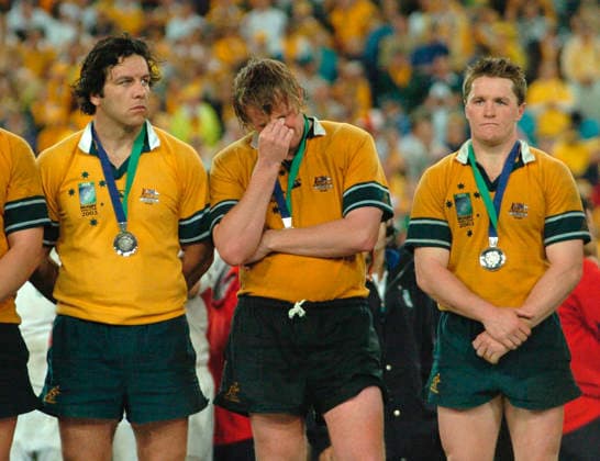 RWC AUSTRALIA ENGLAND, Sydney, November 22, 2003. Dejected Australian players (l to r) Brendan Cannon, Bill Young and Elton Flatley after the Rugby World Cup final between England and Australia at Telstra Stadium in Sydney today. ( SYDNEY NSW Australia  Copyright: xx 20031122000010957878-original
