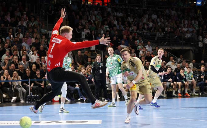 Renars Uscins scores a goal against goalkeeper Lasse Ludwig duel Game scene Action Sport Handball HBL Bundesliga Men 32 Matchday Season 2025 2026 21 05 2026 Füchse Berlin vs TSV Hannover Burgdorf