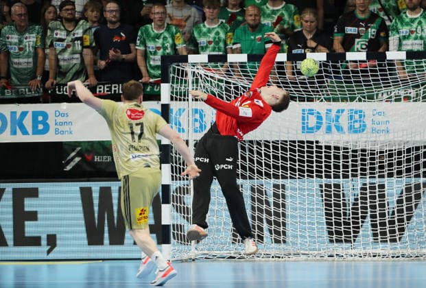 August Pedersen scores a goal against goalkeeper Lasse Ludwig duel Match scene Action Sport Handball HBL Bundesliga Men 32 Matchday Season 2025 2026 21 05 2026 Füchse Berlin vs TSV Hannover Burgdorf
