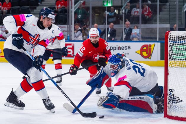 ZURICH, SWITZERLAND - MAY 21: Joshua Tetlow (Great Britain, 24) saving the puck from Mat Robson (Great Britain, 20) and Denis Malgin (Switzerland, 62) during the Preliminary Round - Group A Match 31 between Switzerland and Great Britain at the IIHF Ice hockey, Eishockey World Championship, WM, Weltmeisterschaft 2026, Swiss Life Arena on May 21, 2026 in Zurich, Switzerland. Zurich Switzerland Copyright: xTimoxSteinx