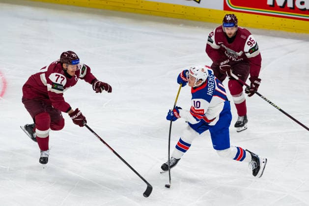 ZURICH, SWITZERLAND - MAY 23: James Hagens (United States, 10) in the battle for the puck with Kristaps Zile (Latvia, 77) during the Preliminary Round - Group A Match 37 between Latvia and United States at the IIHF Ice hockey, Eishockey World Championship, WM, Weltmeisterschaft 2026, Swiss Life Arena on May 23, 2026 in Zurich, Switzerland. Zurich Switzerland Copyright: xTimoxSteinx