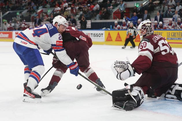 23 05 2026 Swiss Life Arena Zurich , SWITZERLAND, Mens Ice Hockey IIHF World Championship Zurich 2026 Group A LAT USA Mathieu Olivier left,USA in front of goaltender Kristers Gudlevskis LAT