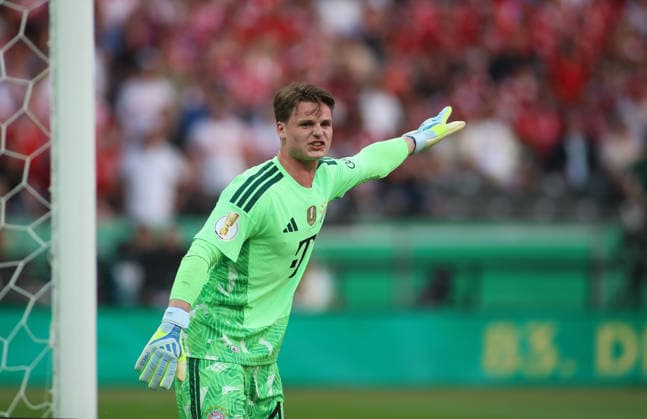 Football, Men, DFB Cup Final, Season 2025 2026, FC Bayern Munich VFB Stuttgart, Olympiastadion Berlin Jonas Urbig FC Bayern Munich raises left arm DFB, DFL regulations prohibit any use of photographs as image sequences and or quasi video