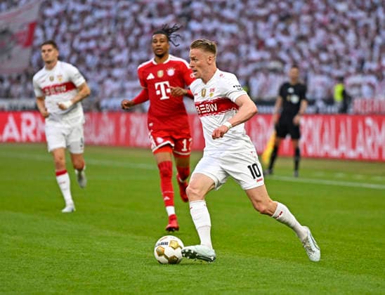 23 05 2026, Football DFB Pokal 2025 2026, Final, FC Bayern Munich VfB Stuttgart, at Olympiastadion Berlin Michael Olise FC Bayern Munich vs Chris Führich Stuttgart DFL and DFB regulations prohibit any use of photographs as image sequences and or quasi video
