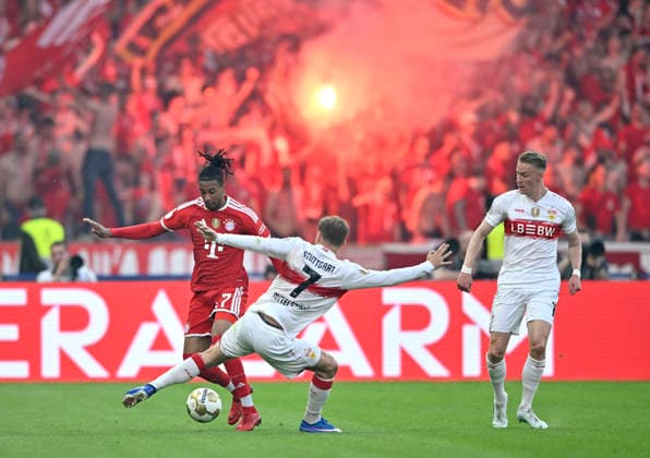 duel, action Michael Olise FC Bayern Muenchen FCB 17 vs Maximilian Mittelstaedt VfB Stuttgart 07 Chris Fuehrich VfB Stuttgart 10 Bengalos, pyrotechnics, pyro, fireworks, 83 DFB Cup Final FC Bayern Muenchen FCB vs VFB Stuttgart Olympiastadion Berlin 23 05 2026 DFL REGULATIONS PROHIBIT ANY USE OF PHOTOGRAPHS AS IMAGE SEQUENCES AND OR QUASI VIDEO 83 DFB Cup Final FC Bayern Muenchen FCB vs VFB Stuttgart