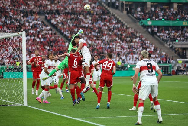 Football, Men, DFB Cup Final, Season 2025 2026, FC Bayern Munich VFB Stuttgart, Olympiastadion Berlin Jonas Urbig FC Bayern Munich in action in the penalty area, fist the ball away against Chema Andres VFB Stuttgart DFB, DFL regulations prohibit any use of photographs as image sequences and or quasi video