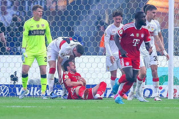 23 05 2026, Football, 83 DFB Pokal Final,, FC Bayern München VfB Stuttgart, Olympioastadion Berlin, Saison 2025 2026 Jeff Chabot VfB Stuttgart 24 directs the Harry Kane FC Bayern Muenchen 09 lying on the ground in the penalty area on his legs DFB regulations prohibit any use of photographs as image sequences and or quasi video Berlin Germany