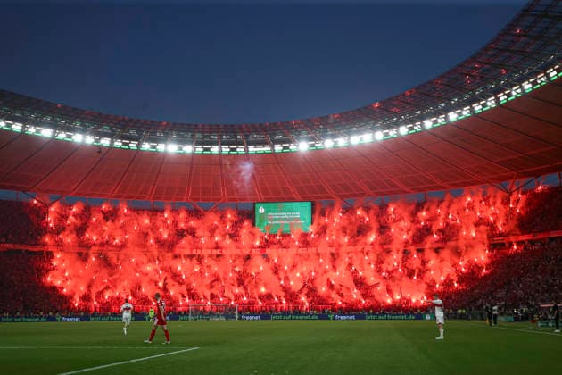 Supporters of FC Bayern München use pyrotechnics during the DFB Cup Final 2026 match between FC Bayern München and VfB Stuttgart at Olympiastadion on May 23, 2026 in Berlin, Germany Photo by Oliver Kaelke DeFodi Images