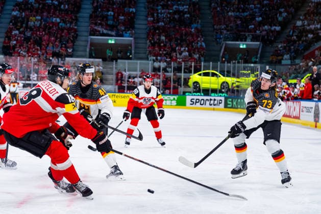 ZURICH, SWITZERLAND - MAY 23: Lukas Reichel (Germany, 73) against Paul Stapelfeld (Austria, 18) during the Preliminary Round - Group A Match 41 between Austria and Germany at the IIHF Ice hockey, Eishockey World Championship, WM, Weltmeisterschaft 2026, Swiss Life Arena on May 23, 2026 in Zurich, Switzerland. Zurich Switzerland Copyright: xTimoxSteinx