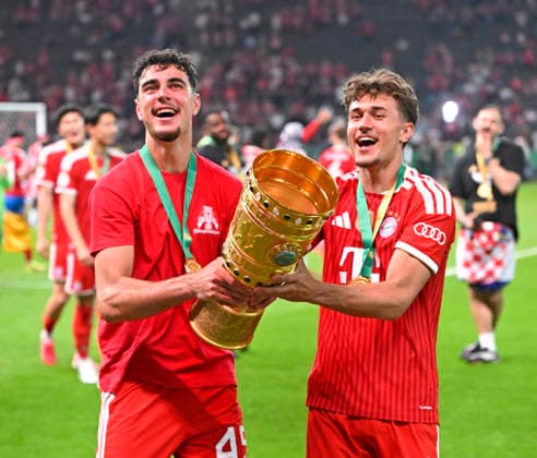 23 05 2026, Football DFB Pokal 2025 2026, Final, FC Bayern Munich VfB Stuttgart, in the Olympiastadion Berlin v l Aleksandar Pavlovic Bayern Munich and Tom Bischof Bayern Munich cheer with the cup DFL and DFB regulations prohibit any use of photographs as image sequences and or quasi video