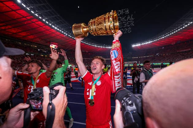 23 05 2026, Football, 83 DFB Pokal Final,, FC Bayern München VfB Stuttgart, Olympioastadion Berlin, Season 2025 2026 FC Bayern München is cup winner after the 3 0 victory Final celebration Joshua Kimmich FC Bayern Muenchen 06 after the match with the trophy DFB regulations prohibit any use of photographs as image sequences and or quasi video Berlin Germany