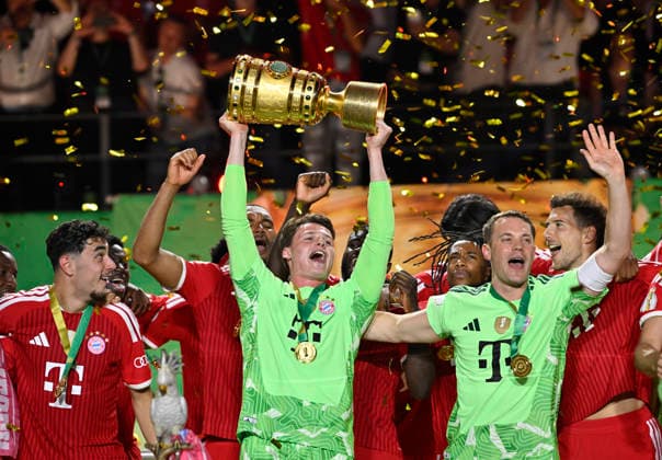 after the end of the match cup handover FC Bayern celebrate victory DFB Cup goalkeeper Manuel Neuer FC Bayern Muenchen FCB 01 goalkeeper Jonas Urbig FC Bayern Muenchen FCB 40 Aleksandar Pavlovic FC Bayern Muenchen FCB 45 83 DFB Cup final FC Bayern Muenchen FCB vs VFB Stuttgart Olympiastadion Berlin 23 05 2026 DFL REGULATIONS PROHIBIT ANY USE OF PHOTOGRAPHS AS IMAGE SEQUENCES AND OR QUASI VIDEO 83 DFB Pokal Final FC Bayern Muenchen FCB vs VFB Stuttgart