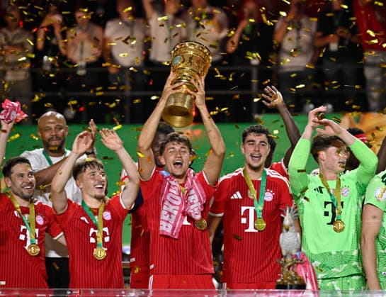 after the end of the match FC Bayern celebrate victory DFB Cup Tom Bischof FC Bayern Muenchen FCB 20 Lennart Karl Bayern Muenchen FCB 42 Aleksandar Pavlovic FC Bayern Muenchen FCB 45 Goalkeeper Jonas Urbig FC Bayern Muenchen FCB 40 Raphael Guerreiro FC Bayern Muenchen FCB 22 83 DFB Cup Final FC Bayern Muenchen FCB vs VFB Stuttgart Olympiastadion Berlin 23 05 2026 DFL REGULATIONS PROHIBIT ANY USE OF PHOTOGRAPHS AS IMAGE SEQUENCES AND OR QUASI VIDEO 83 DFB Cup Final FC Bayern Muenchen FCB vs VFB Stuttgart