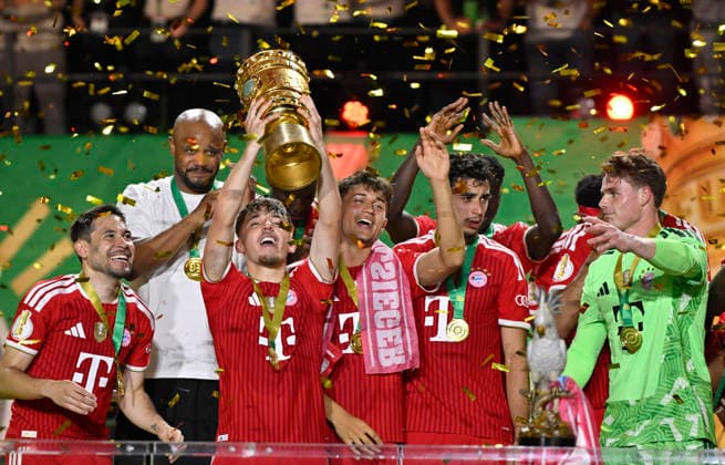 after the end of the match FC Bayern celebrate victory DFB Cup Tom Bischof FC Bayern Muenchen FCB 20 Lennart Karl Bayern Muenchen FCB 42 Aleksandar Pavlovic FC Bayern Muenchen FCB 45 Goalkeeper Jonas Urbig FC Bayern Muenchen FCB 40 Raphael Guerreiro FC Bayern Muenchen FCB 22 83 DFB Cup Final FC Bayern Muenchen FCB vs VFB Stuttgart Olympiastadion Berlin 23 05 2026 DFL REGULATIONS PROHIBIT ANY USE OF PHOTOGRAPHS AS IMAGE SEQUENCES AND OR QUASI VIDEO 83 DFB Cup Final FC Bayern Muenchen FCB vs VFB Stuttgart