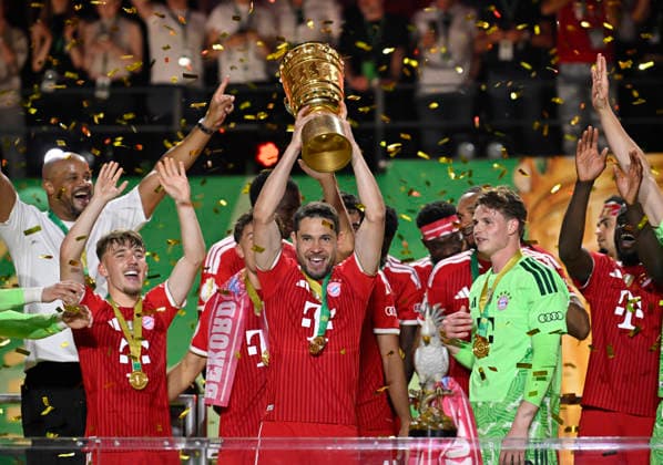 after the end of the match cup handover FC Bayern celebrate victory DFB Cup Raphael Guerreiro FC Bayern Muenchen FCB 22 Lennart Karl Bayern Muenchen FCB 42 Goalkeeper Jonas Urbig FC Bayern Muenchen FCB 40 Coach Coach Vincent Kompany FC Bayern Muenchen FCB 83 DFB Cup Final FC Bayern Muenchen FCB vs VFB Stuttgart Olympiastadion Berlin 23 05 2026 DFL REGULATIONS PROHIBIT ANY USE OF PHOTOGRAPHS AS IMAGE SEQUENCES AND OR QUASI VIDEO 83 DFB Cup Final FC Bayern Muenchen FCB vs VFB Stuttgart