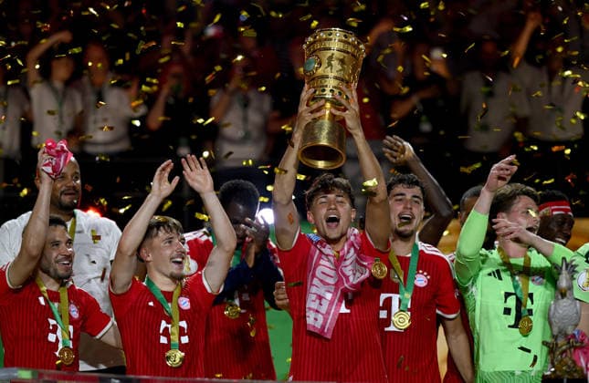 Football DFB Cup Final 2025 2026 in Berlin FC Bayern Muenchen VfB Stuttgart 23 05 2026 Winner FC Bayern Muenchen cheers on the podium from left , Raphael Guerreiro, Lennart Karl, Tom Bischof , Aleksandar Pavlovic