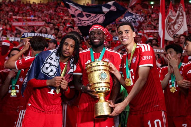 DFB Cup Final FC Bayern Munich VfB Stuttgart on 23 05 2026 at the Olympiastadion in Berlin Michael Olise Muenchen 17 , Alphonso Davies Muenchen 19 and Jamal Musiala Muenchen 10 pose together with the trophy for a photo MH