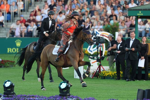 Richard Vogel and Luciana Diniz together in Bond Stunt Feeling over the obstacles, concert horse symphony, supporting program, motto of the evening James Bond, World Equestrian Festival, TSCHIO Aachen 2026, TSCHIO instead of CHIO 2026, Aachener Soers, 22 to 24 May 2026, equestrian sport, 23 05 2026, Aachener Soers Germany