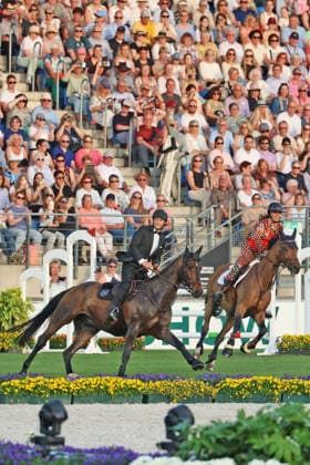 Richard Vogel and Luciana Diniz together in Bond Stunt Feeling over the obstacles, concert horse symphony, supporting program, motto of the evening James Bond, World Equestrian Festival, TSCHIO Aachen 2026, TSCHIO instead of CHIO 2026, Aachener Soers, 22 to 24 May 2026, equestrian sport, 23 05 2026, Aachener Soers Germany