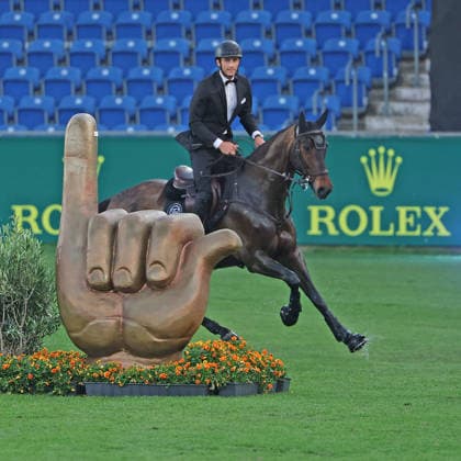 Richard Vogel in a tuxedo through the Aachen Soers and past the Öcher Klenkes obstacle and finger pointing, greeting from the people of Aachen, Horse Symphony concert, supporting program, motto of the evening James Bond, World Equestrian Festival, World Equestrian Festival, TSCHIO Aachen 2026, TSCHIO instead of CHIO 2026, Aachener Soers, May 22nd to 24th 2026, equestrian sport, May 23rd 2026, Aachener Soers Germany