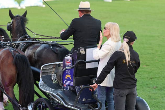 Britt Ekland, the legendary Bond Girl from the film The Man with the Golden Gun, took her place on the coach box behind the World Champion Boyd Exell, concert horse symphony, supporting program, motto of the evening James Bond, World Equestrian Festival, TSCHIO Aachen 2026, TSCHIO instead of CHIO 2026, Aachener Soers, 22 to 24 May 2026, equestrian sport, 23 05 2026, Aachener Soers Germany
