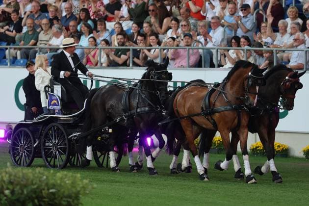 Britt Ekland took a seat on the coach box behind the World Champion Boyd Exell Ð the legendary Bond Girl from the film ÒThe Man with the Golden GunÓ , concert horse symphony, supporting program, motto of the evening James Bond, World Equestrian Festival, TSCHIO Aachen 2026, TSCHIO instead of CHIO 2026, Aachener Soers, 22 to 24 May 2026, equestrian sport, 23 05 2026, Aachener Soers Aachen Germany