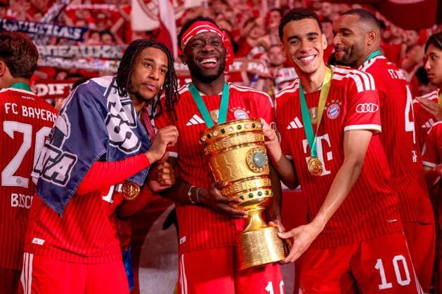 23 05 2026, Football, 83 DFB Pokal Final, FC Bayern München VfB Stuttgart, Olympioastadion Berlin, Season 2025 2026 FC Bayern München is cup winner after the 3 0 victory Winners celebration Michael Olise FC Bayern Muenchen 17 Alphonso Davies FC Bayern Muenchen 19 Jamal Musiala FC Bayern Muenchen 10 with the cup in his hand DFB regulations prohibit any use of photographs as image sequences and or quasi video Berlin Germany