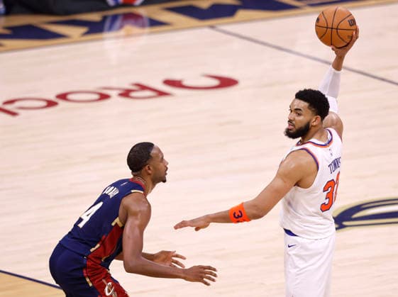 New York Knicks Karl-Anthony Towns (32) looks to pass the ball while defended by Cleveland Cavaliers Evan Mobley (4)during the second quarter of their Eastern Conference Final game in Cleveland, Ohio Saturday May 23, 2026.  CLE20260523123 AARONxJOSEFCZYK