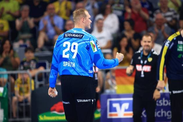 David Späth 29, goalkeeper, Rhein Neckar Löwen clenches his fist and cheers after a save in the SAP Arena The Löwen coaching team can be seen in the background Goalkeeper David Späth 29 of Rhein Neckar Löwen cheers in the SAP Arena Copyright: xspeedshotx