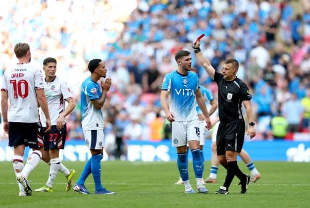 Josh Dacres-Cogley of Stockport County (left) is shown a red card by referee Josh Smith after a hair pull on Ibrahim Cissoko of Bolton Wanderers (not pictured) Bolton Wanderers v Stockport County, EFL Sky Bet League One, Play-Off Final, Football, Wembley Stadium, London, UK - 24 May 2026London Wembley Stadium United Kingdom EDITORIAL USE ONLY No use with unauthorised audio, video, data, fixture lists, club league logos or live services. Online in-match use limited to 120 images, no video emulation. No use in betting, games or single club league player publications.  Copyright: xSimonxDael Shutterstockx 16889811fj