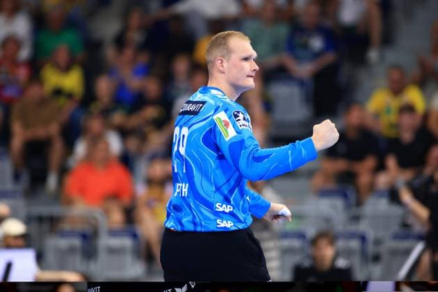Goalkeeper David Späth 29 of the Rhein Neckar Löwen clenches his fist in jubilation in the SAP Arena He wears the Löwens blue goalkeeper jersey with the number 29 David Späth 29 Rhein Neckar Löwen clenches his fist Copyright: xspeedshotx