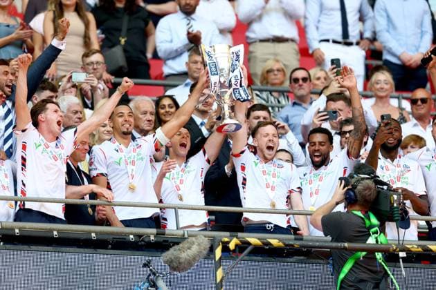 George Johnston of Bolton Wanderers celebrate with the trophy after winning the EFL Championship Play-off Final and promotion to the Premier League Bolton Wanderers v Stockport County, EFL Sky Bet League One, Play-Off Final, Football, Wembley Stadium, London, UK - 24 May 2026London Wembley Stadium United Kingdom EDITORIAL USE ONLY No use with unauthorised audio, video, data, fixture lists, club league logos or live services. Online in-match use limited to 120 images, no video emulation. No use in betting, games or single club league player publications.  Copyright: xSimonxDael Shutterstockx 16889811ga