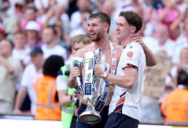 John McAtee of Bolton Wanderers (left) and Johnny Kenny of Bolton Wanderers celebrate with the trophy after winning the EFL Championship Play-off Final and promotion to the Premier League Bolton Wanderers v Stockport County, EFL Sky Bet League One, Play-Off Final, Football, Wembley Stadium, London, UK - 24 May 2026London Wembley Stadium United Kingdom EDITORIAL USE ONLY No use with unauthorised audio, video, data, fixture lists, club league logos or live services. Online in-match use limited to 120 images, no video emulation. No use in betting, games or single club league player publications.  Copyright: xKieranxMcManus Shutterstockx 16889802eg