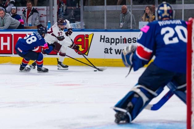 ZURICH, SWITZERLAND - MAY 24: Haralds Egle (Latvia, 97) in the battle for the puck with David Clements (Great Britain, 58) during the Preliminary Round - Group A Match 43 between Great Britain and Latvia at the IIHF Ice hockey, Eishockey World Championship, WM, Weltmeisterschaft 2026, Swiss Life Arena on May 24, 2026 in Zurich, Switzerland. Zurich Switzerland Copyright: xTimoxSteinx