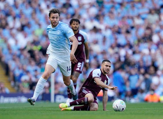 Manchester, England, 24th May 2026. Nico Gonzalez of Manchester City tussles with Emiliano Buendia of Aston Villa during the Manchester City vs Aston Villa Premier League match at the Etihad Stadium, Manchester. Picture credit should read: Andrew Yates Sportimage EDITORIAL USE ONLY. No use with unauthorised audio, video, data, fixture lists, club league logos or live services. Online in-match use limited to 120 images, no video emulation. No use in betting, games or single club league player publications. SPI_011_AY_Man_City_Villa SPI-4819-0019