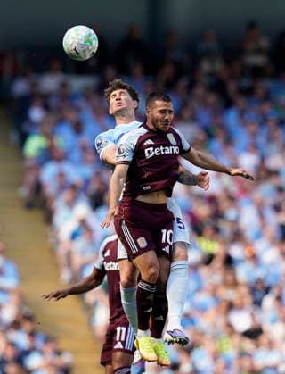 Manchester, England, 24th May 2026. John Stones of Manchester City tussles with Emiliano Buendia of Aston Villa during the Manchester City vs Aston Villa Premier League match at the Etihad Stadium, Manchester. Picture credit should read: Andrew Yates Sportimage EDITORIAL USE ONLY. No use with unauthorised audio, video, data, fixture lists, club league logos or live services. Online in-match use limited to 120 images, no video emulation. No use in betting, games or single club league player publications. SPI_021_AY_Man_City_Villa SPI-4819-0026
